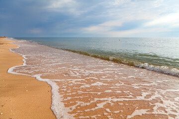 Waves on the summer sea beach.