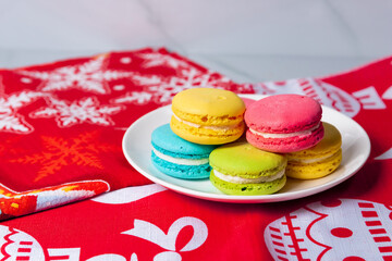 macaroon cookies lie in a plate on a New Year's napkin