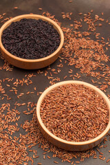 Brown rice in ceramic bowl. Black rice in ceramic bowl