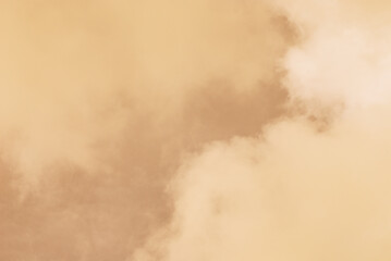 Soft and warm cloudy day in close up sky background. Natural border in golden light color of sky and clouds.