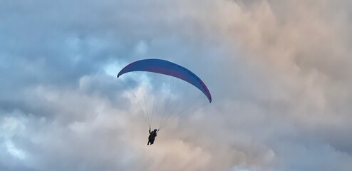 Paraglider  on a misty day over a dramatic sky