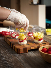 Close-up of a pastry chef preparing trifles