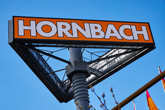 Berlin, Germany - April 4, 2020: Large sign for a hardware store in Germany with a mast that is designed like an oversized screw.