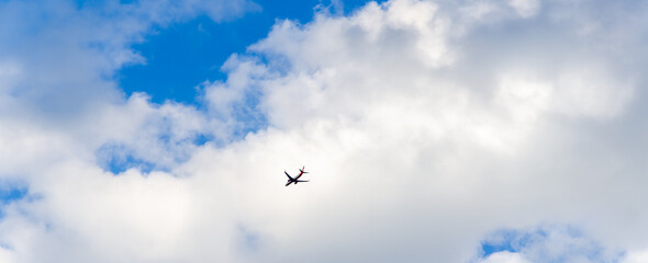 Panorama of blue sky and airplane on cumulus clouds background
