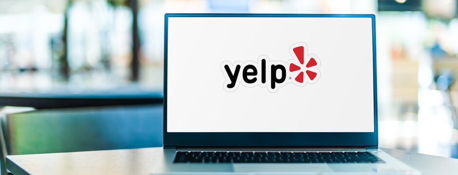 Laptop Computer Displaying Logo Of Yelp