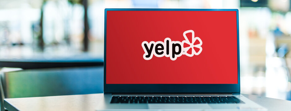 Laptop Computer Displaying Logo Of Yelp