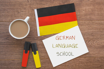 german national flag, notebook with the inscription german language school, two markers, cup of...