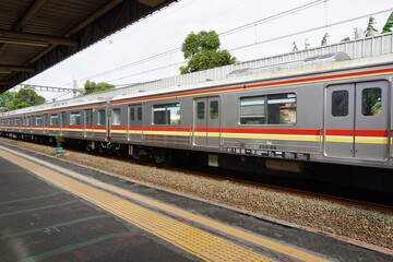 Fototapeta na wymiar Commuter Line (train) arrives at a station railway station, Jakarta.