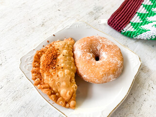 donut sugar and pastel is kind of snack for breakfast in indonesia. served on white plate.