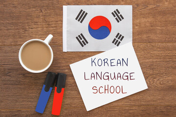 korean national flag, notebook with the inscription korean language school, two markers, cup of...