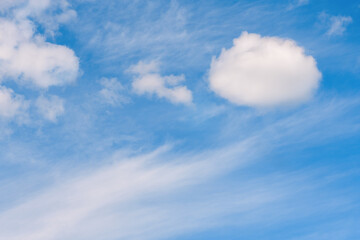 Beautiful oval white clouds are in blue sky.