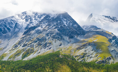 closeup mountain in a snow and dense clouds