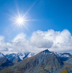 Fototapeta na wymiar mountain chain in a snow under a sparkle sun