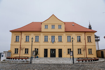 Cultural house Rip, Narrow picturesque street with baroque and renaissance historical buildings at Hus Square in winter day, Roudnice nad Labem, Central Bohemia, Czech Republic