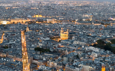 Aerial view of Paris at twilight with the city illuminated