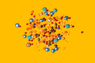 Multi colored beads on yellow background