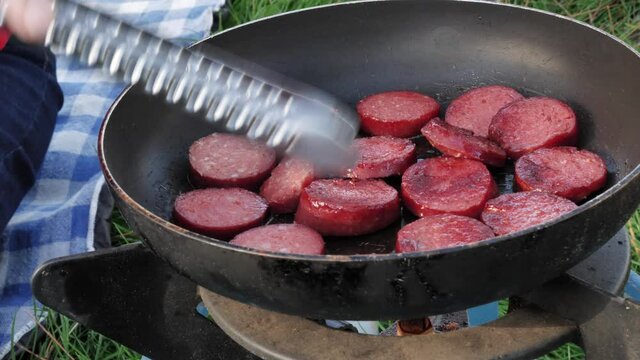 lady cooking frying sucuk meat outdoors  cooking food