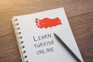 national flag of Turkey, a notebook with the inscription learn turkish online, the concept of...