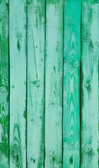 Shabby weathered wooden wall painted of bright green paint