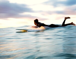 Slow shutter - A longboard surfer gliding into a blue wave at Snapper Rocks