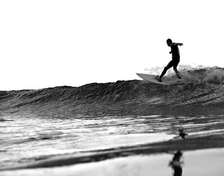 Surfer doing a top turn with white background, black and white