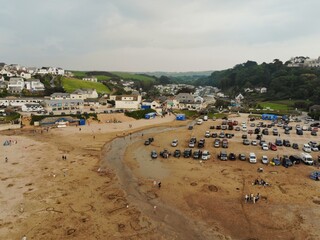 A large group of cars parked on the sand beach at Polzeath - Cornwall