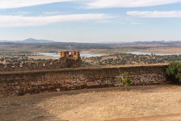 Interior of Terena Castle with a dam lake reservoir on the background and the village of Terena in Alentejo, Portugal