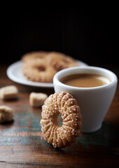 Butter cookie and a cup of Coffee  on rustic wooden background. Close up.