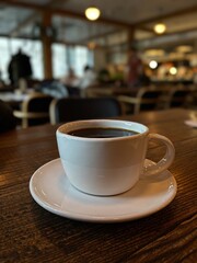 Fototapeta premium black coffee in a white cup in a cafe