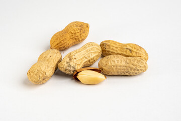 Heap of raw peanuts in shells without salt close up detail on neutral background