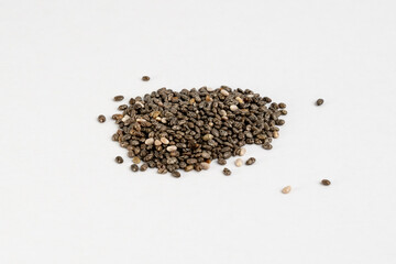 Heap of raw hemp seeds on a neutral background