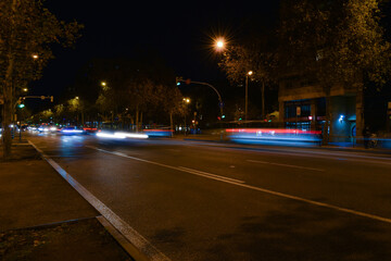 Buses and cars moving at night on the road.