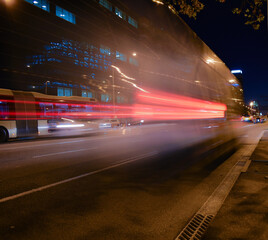 Fototapeta premium Buses and cars moving at night on the road.