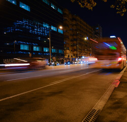 Fototapeta premium Buses and cars moving at night on the road.