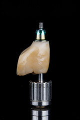 dental crown from yellow zircon on a black background