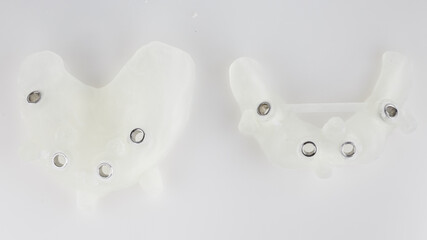 two surgical templates for total implantation on a white background