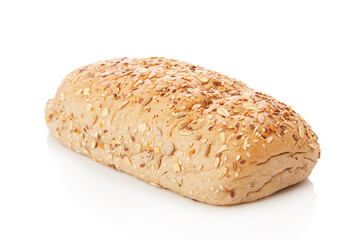 long loaf of multigrain whole wheat bread on white background.