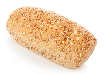 long loaf of multigrain whole wheat bread on white background.