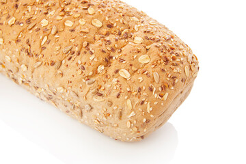 long loaf of multigrain whole wheat bread on white background.