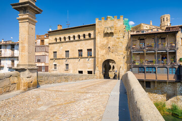 View from the medieval bridge the tower of the Valderrobres Town Hall that gives access to the medieval historic center. Aragon, Spain