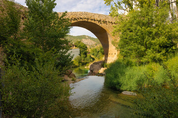View of the medieval bridge of the Matarranya river from Beceite, Aragon, Spain