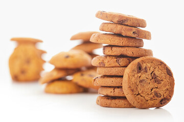 Stack of Chocolate chip cookies on white.