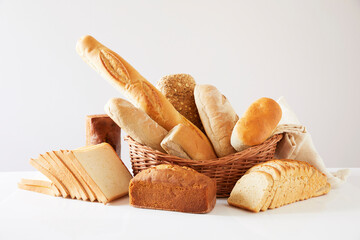 Basket with assorted baking products on white background.