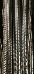 many stainless steel braided flex-hose pieces as abstract patterns and designs 