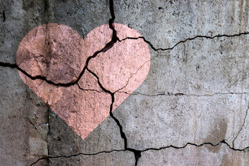 A broken heart. Drawing of a heart on a cracked wall. Broken relationships. Treason and betrayal....
