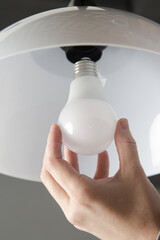 Replacing light bulb at home. Simple DIY housework maintaince.	
