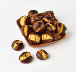 Roasted chestnut on wooden plate..