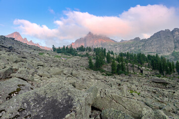 Taiga. Siberia. Dawn in the mountains in the parking lot near the peak 