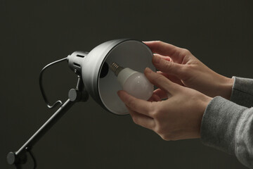 Replacing light bulb at home. Simple DIY housework maintaince.	
