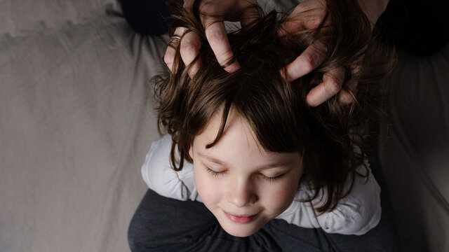 Mom Gives Head Massage To Daughter At Home Top View